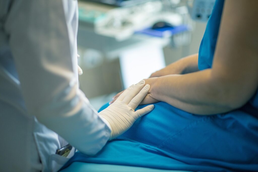 Image of doctor chatting with patient | Angela Griffith Law