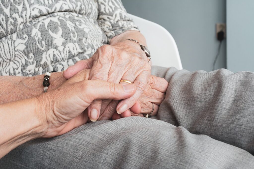 Image of elderly couple holding hands | Angela Griffith Law