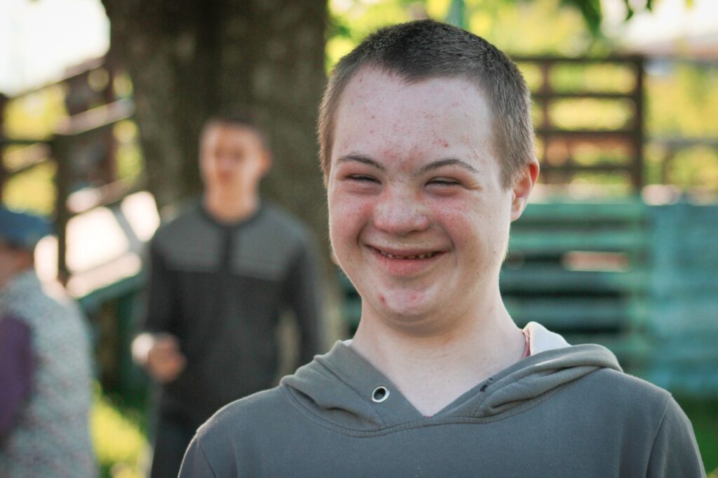 Image of boy with special needs smiling | Angela Griffith Law